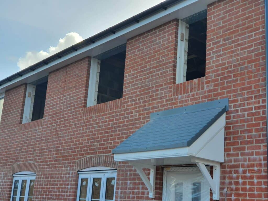 A block and brick built new construction home with some windows not installed