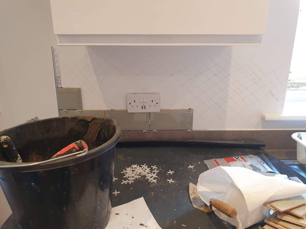 Tiling drywall by scoring the wall first with a knife