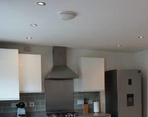 An extractor fan and cooker hood extractor in a kitchen