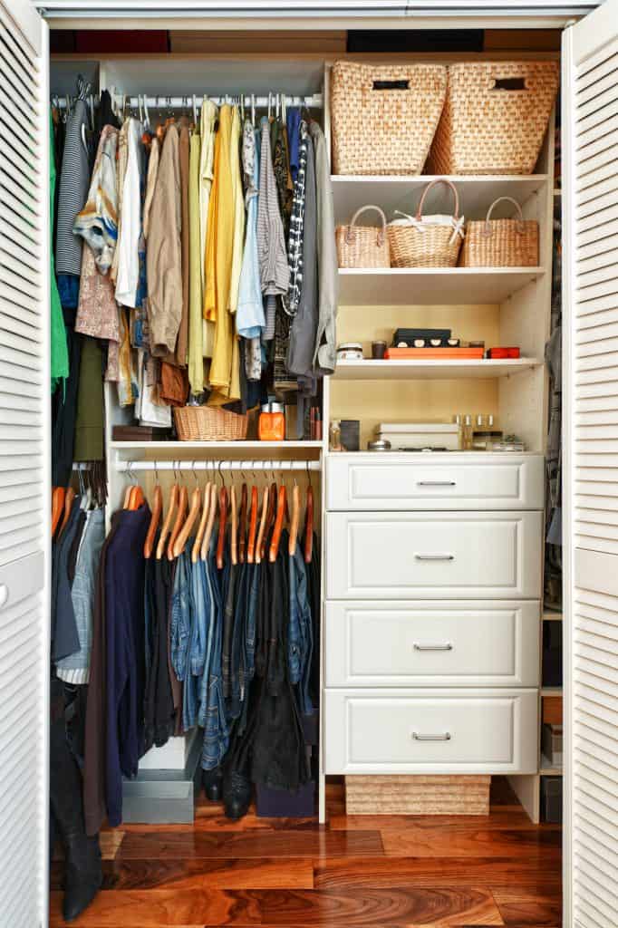 An organized closet with rails and shelves