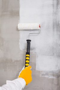 Applying an initial scratch coat to a plaster wall