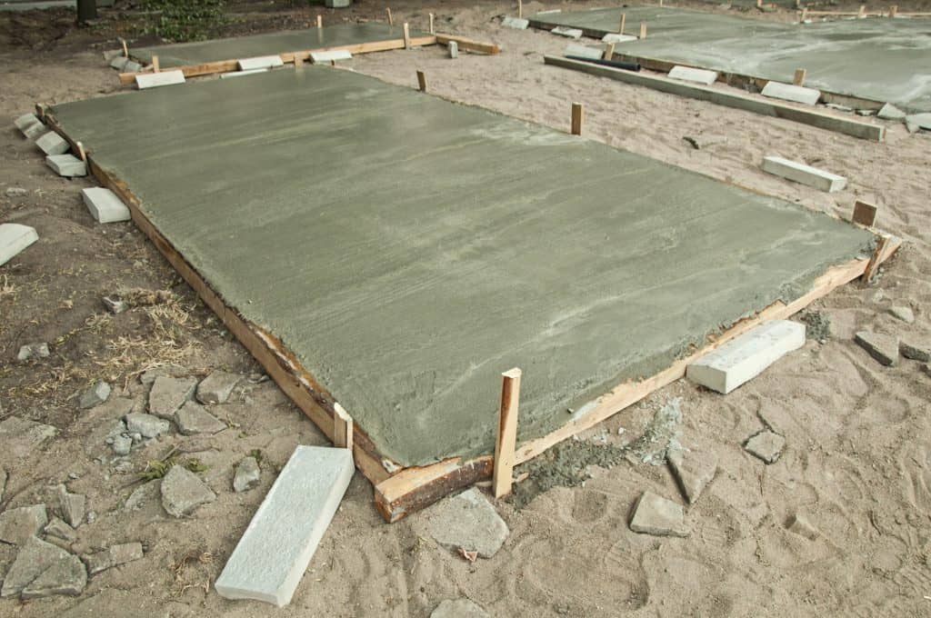 A smaller concrete slab possibly for a garage or outbuilding