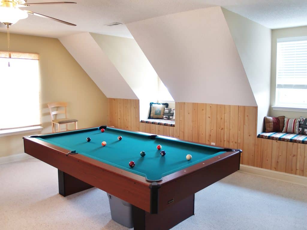 A bonus room with a pool table in it