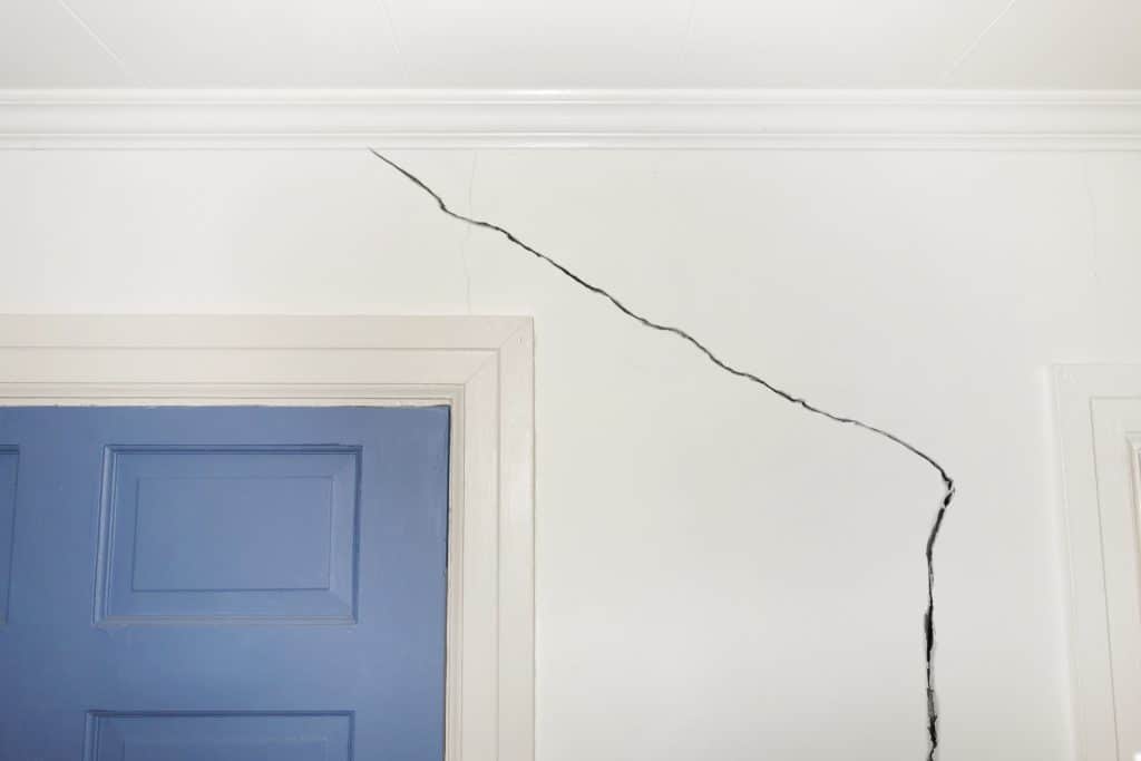 An internal crack down a wall just above a door frame